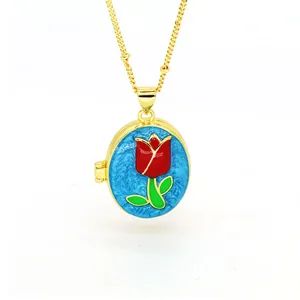 Detailed view of vintage 18k gold oval locket necklace with red tulip enamel design