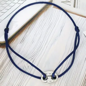 Detailed shot of a blue adjustable cord bracelet with a silver pig nose charm