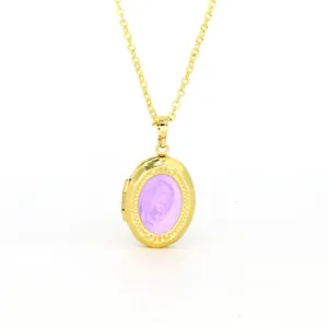 Close-up view of a golden oval locket pendant featuring a swirling purple enamel center.