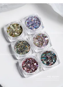 Detailed macro shot of various colorful hexagonal nail sequins in clear plastic jars