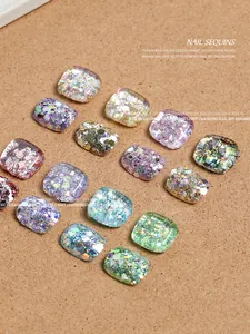 Macro view of multi-colored iridescent square nail sequins with brilliant sparkle effects