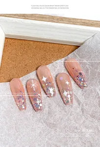Close-up of Japanese style hexagonal iridescent nail sequins on pink press-on nails
