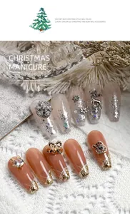 Detailed macro shot of luxury Christmas nail charms featuring elk and snowflake patterns
