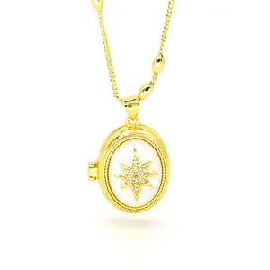 Close-up view of gold oval locket necklace featuring a sparkling North Star motif