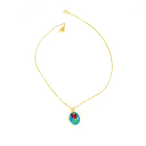 Detailed view of an 18k gold necklace featuring an oval tulip floral enamel locket