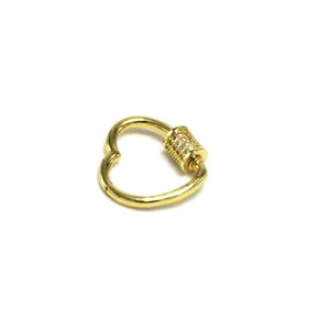 Detailed macro view of heart-shaped gold screw clasp decorated with pavé cubic zirconia