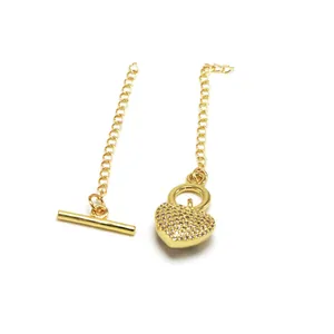 Detail view of golden pave heart pendant and toggle bar jewelry accessories for DIY