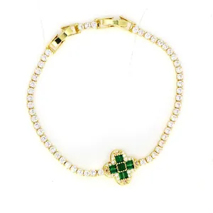 Detailopname van vergulde armband met groen en wit zirkonia klavertje vier