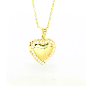 Detailed view of a gold heart-shaped locket necklace featuring a delicate pearl border design