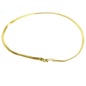 Detailed macro shot of an elegant 18k gold plated flat snake bone chain necklace design