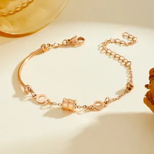Macro detail of rose gold titanium steel bracelet with geometric cylindrical bead accent