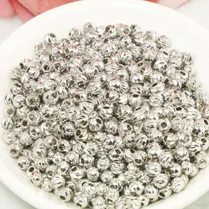 Macro shot of silver diamond-cut textured metal spacer beads for DIY jewelry making