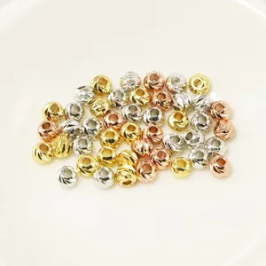 Detailed macro shot of 18k gold-plated 11-cut engraved spacer beads for DIY jewelry