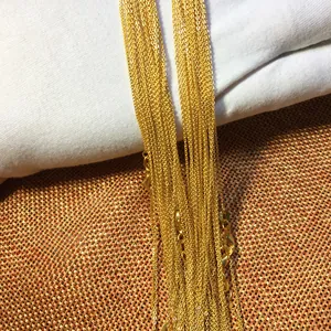 Detailed macro view showing the intricate texture of golden water wave chain necklaces