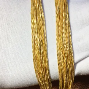 Detailed macro view of 24K golden box chain necklaces showing intricate texture
