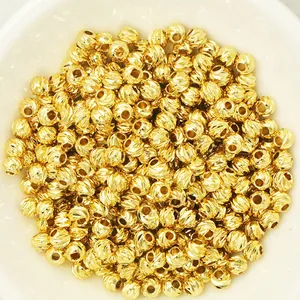 Macro view of textured 18k gold plated faceted spacer beads for DIY jewelry making.