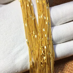 Close-up detail of luxurious 24K gold-plated sand gold water wave chain necklaces