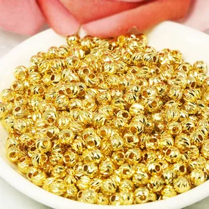 Macro detail of shiny 18k gold-filled diamond-cut loose spacer beads for DIY jewelry making