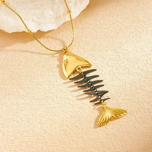 Detailed view of a unique PVD plated stainless steel fishbone necklace with a gold finish
