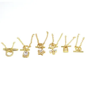 Collection of gold-toned OT toggle clasps with rhinestone charms for DIY jewelry making.