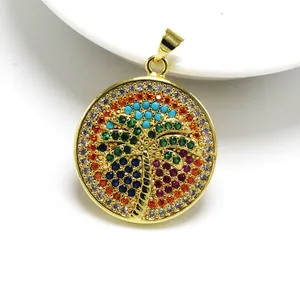 Detailed view of a gold-plated circular pendant featuring a colorful palm tree design