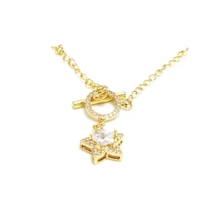 Detail shot of gold OT toggle clasp with a sparkling star pendant and chain link