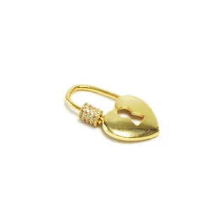 Macro view of a gold-plated heart-shaped screw clasp with zircon inlay for jewelry DIY
