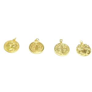 Detailed view of four distinct gold-plated religious charms for DIY jewelry making.
