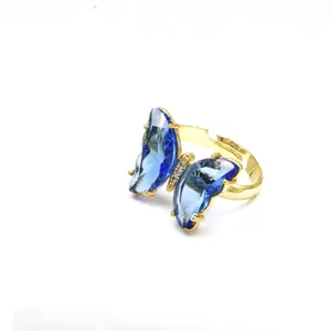 Detailansicht eines eleganten Gold-Schmetterlingsrings mit leuchtend blauen Kristallflügeln