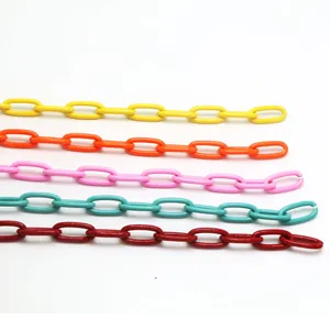 Close-up of colorful DIY geometric chain links in yellow, orange, pink, teal, and red.