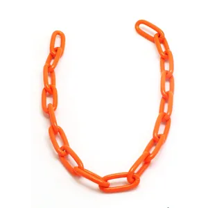 Close-up of bright orange acrylic chain links for punk hip hop jewelry DIY projects