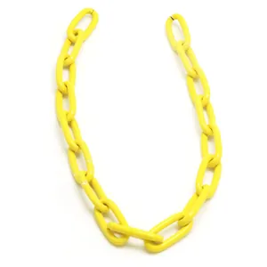 Close-up of yellow chunky chain links in punk hip-hop style for DIY accessories