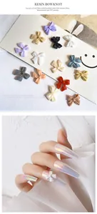 Detail showing various colors of 3D resin bowknot charms for nail art DIY