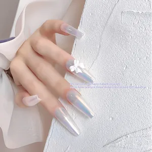 Exquisite white 3D resin bow nail art charm shown on long pearlescent iridescent coffin nails