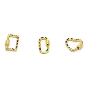 Detailed view of three gold-plated jewelry clasps with multi-color stones in heart, oval and rectangle shapes.