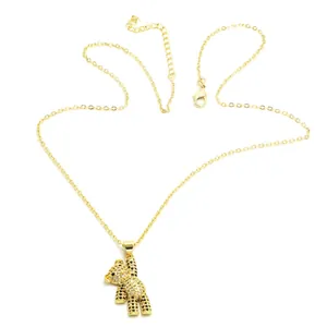 Detail of golden bear pendant necklace with black and clear stones