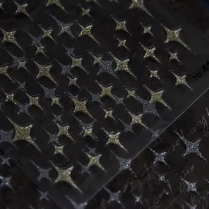 Detailed close-up shot of 3D glitter star nail stickers in gold and silver finish
