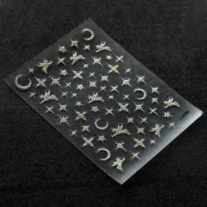 Detailed view of silver glitter nail stickers with star, moon, and Pegasus patterns