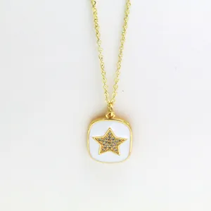Close-up of a gold star pendant necklace with white enamel background and sparkling crystals