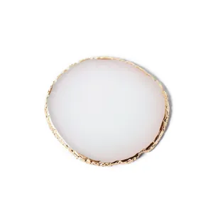Elegant white resin nail art palette with textured gold rim for polish mixing and display