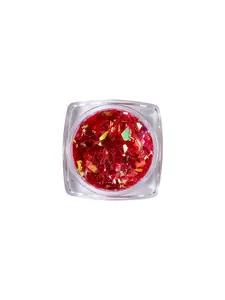 Vibrant iridescent red aurora cellophane nail art flakes in a clear square jar packaging