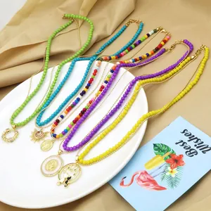 Close-up detail of colorful dopamine beaded double-layer necklaces with cat pendants.