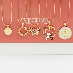 Detailed view of five gold ball chain necklaces featuring various fashion pendants
