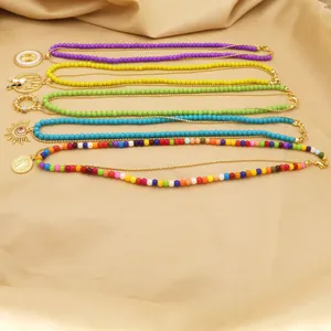 Detailed view of colorful layered bead necklaces featuring cat and evil eye charms