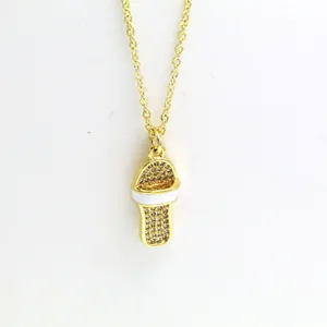 Detailed view of a gold-toned slipper pendant necklace with sparkling crystals and enamel.