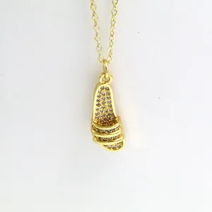Close-up of gold-plated slide sandal pendant necklace with sparkling rhinestones