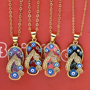 Close-up of four flip-flop shaped evil eye pendants in purple red pink and black