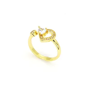 Gros plan d'une élégante bague cœur en or ornée de pierres de zircon et anneau ouvert chic.