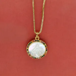 Close-up of gold Virgin Mary shell pendant necklace with colorful zircon stones