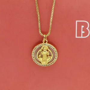 Macro view of gold round shell Maria pendant necklace with white zirconia pave detail